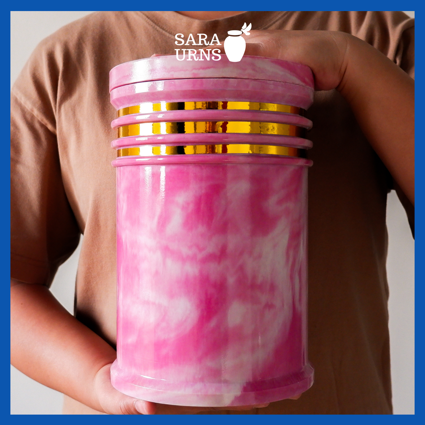 A presentation of a pink cultured marble urn held by an adult woman with two hands.