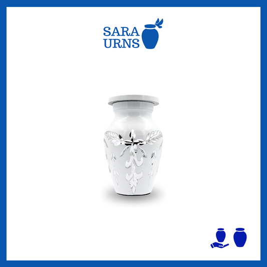 A white aluminum metal keepsake urn with an engraved gem-like design over a white background.