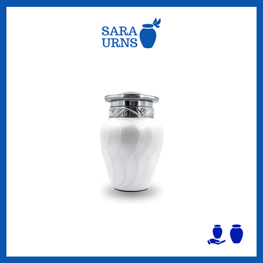 A white aluminum metal keepsake urn with a silver hand-etched design over a white background.