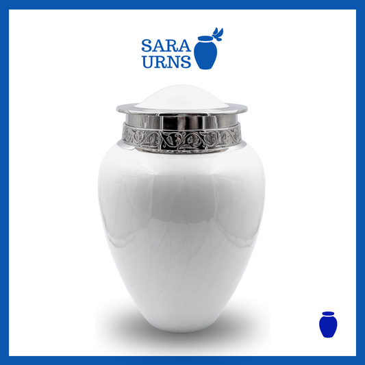 A white polished brass metal urn with an enamel finish and hand-etched details over a white background.