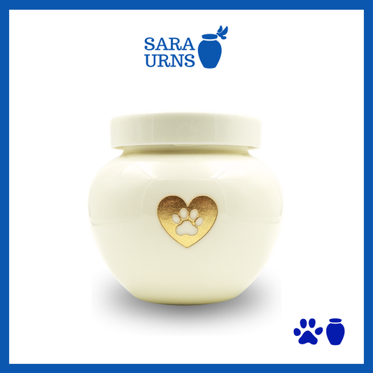 A beige polished ceramic pet urn with a gold metallic foiled heart at its center over a white background.