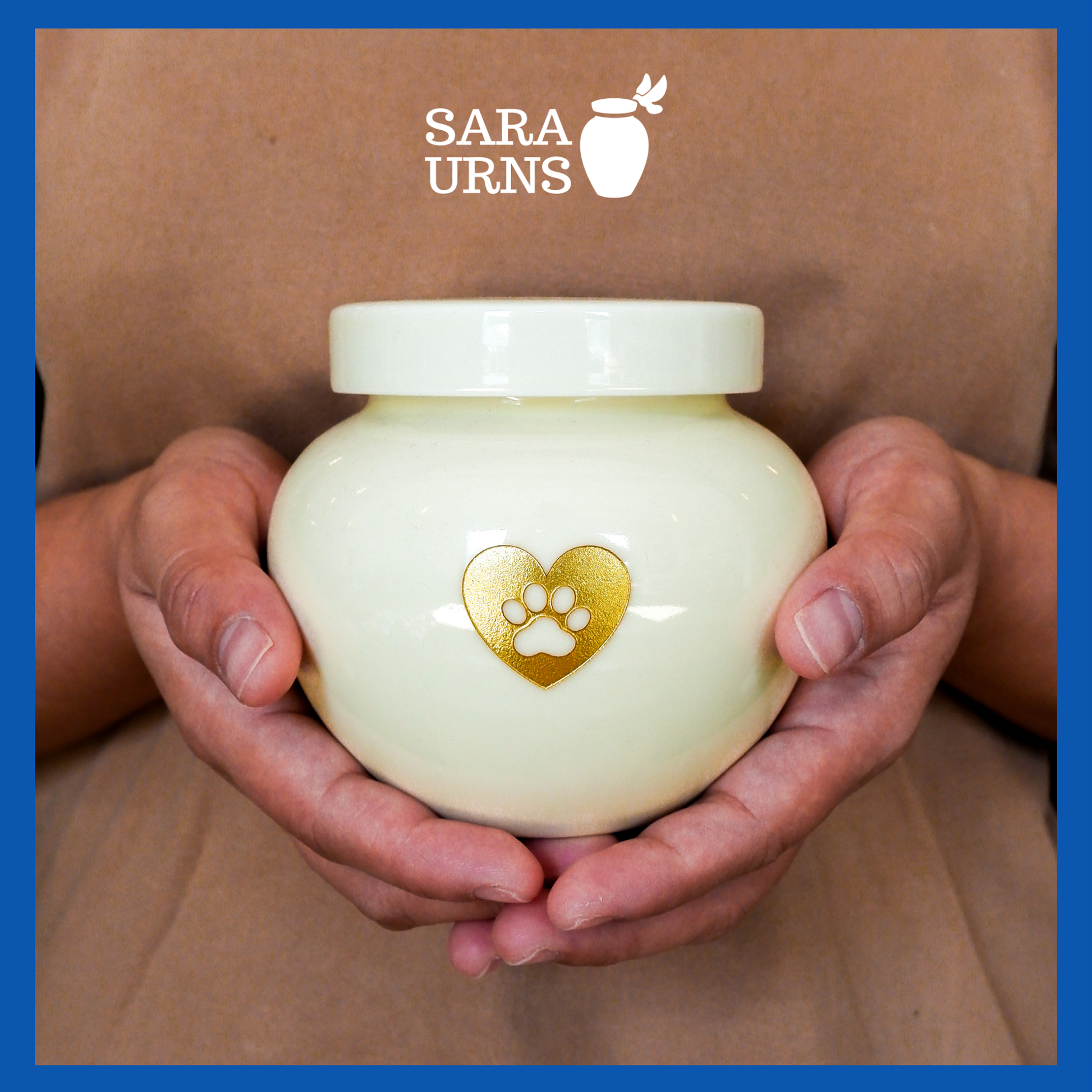 A presentation of a beige polished ceramic pet urn held by an adult woman with two palms.