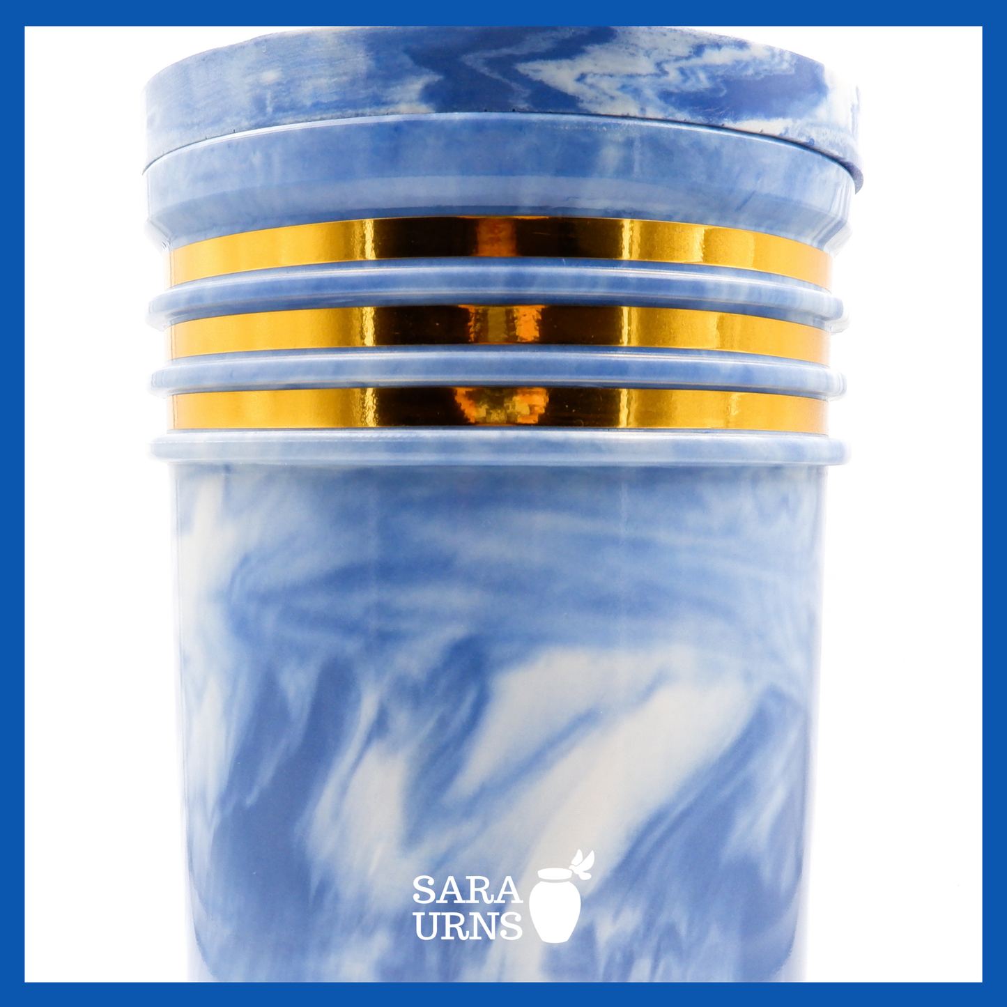 A close-up angle of a blue cultured marble urn which highlights its abstract, liquid marble pattern and gold detail.
