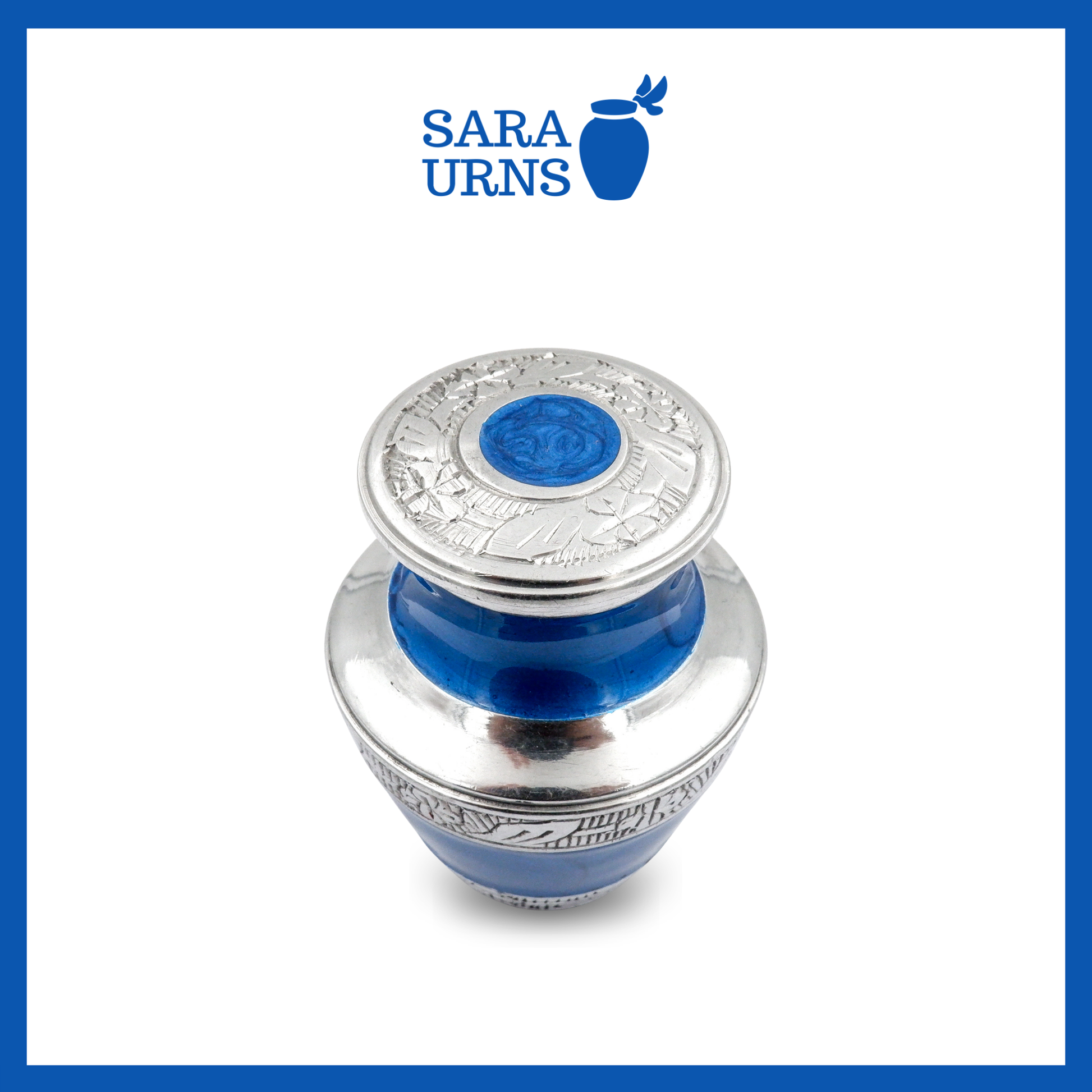 A higher angle of a blue aluminum metal keepsake urn with silver hand-etched designs across the body and lid over a white background.