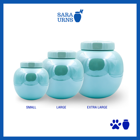 Blue ceramic pet urns with a pearly finish and an embossed paw detail in the lid over a white background.