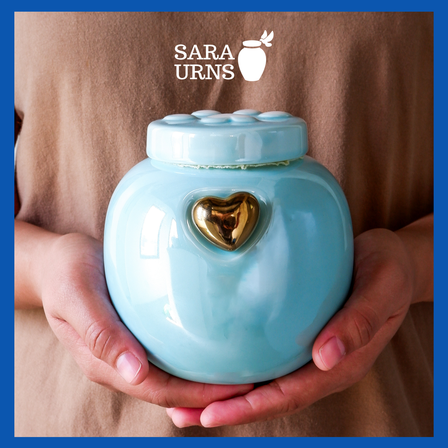 A presentation of a blue ceramic pet urn held by an adult woman with two palms.