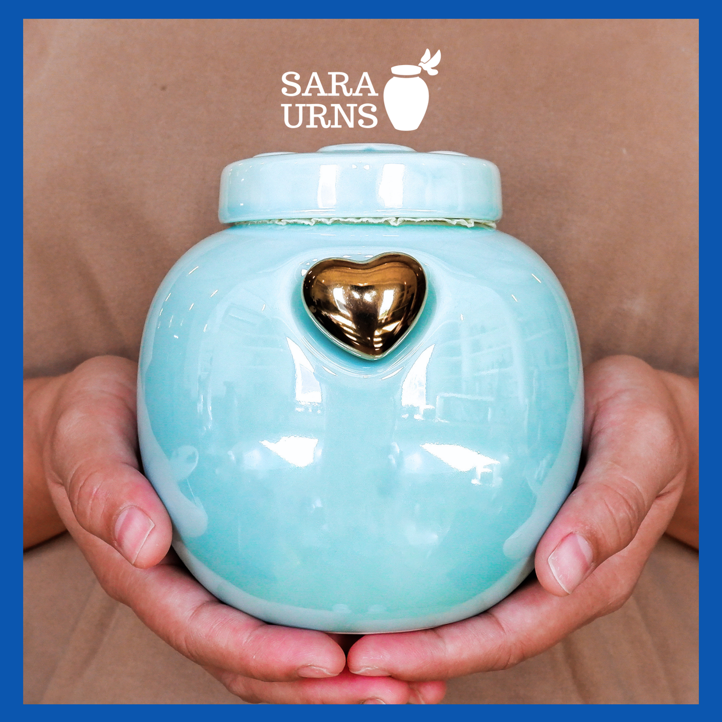 A presentation of a blue ceramic pet urn held by an adult woman with two palms.