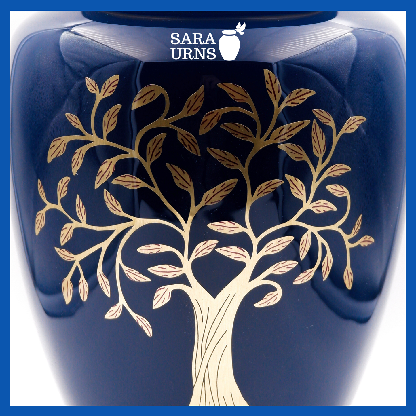 A close-up angle of a blue polished aluminum metal urn which highlights its blue polished finish and golden, hand-etched tree of life detail.