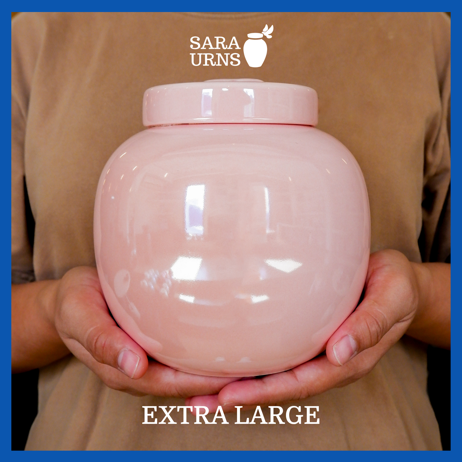 A presentation of an extra large, pink pearly ceramic pet urn held by an adult woman with two palms.