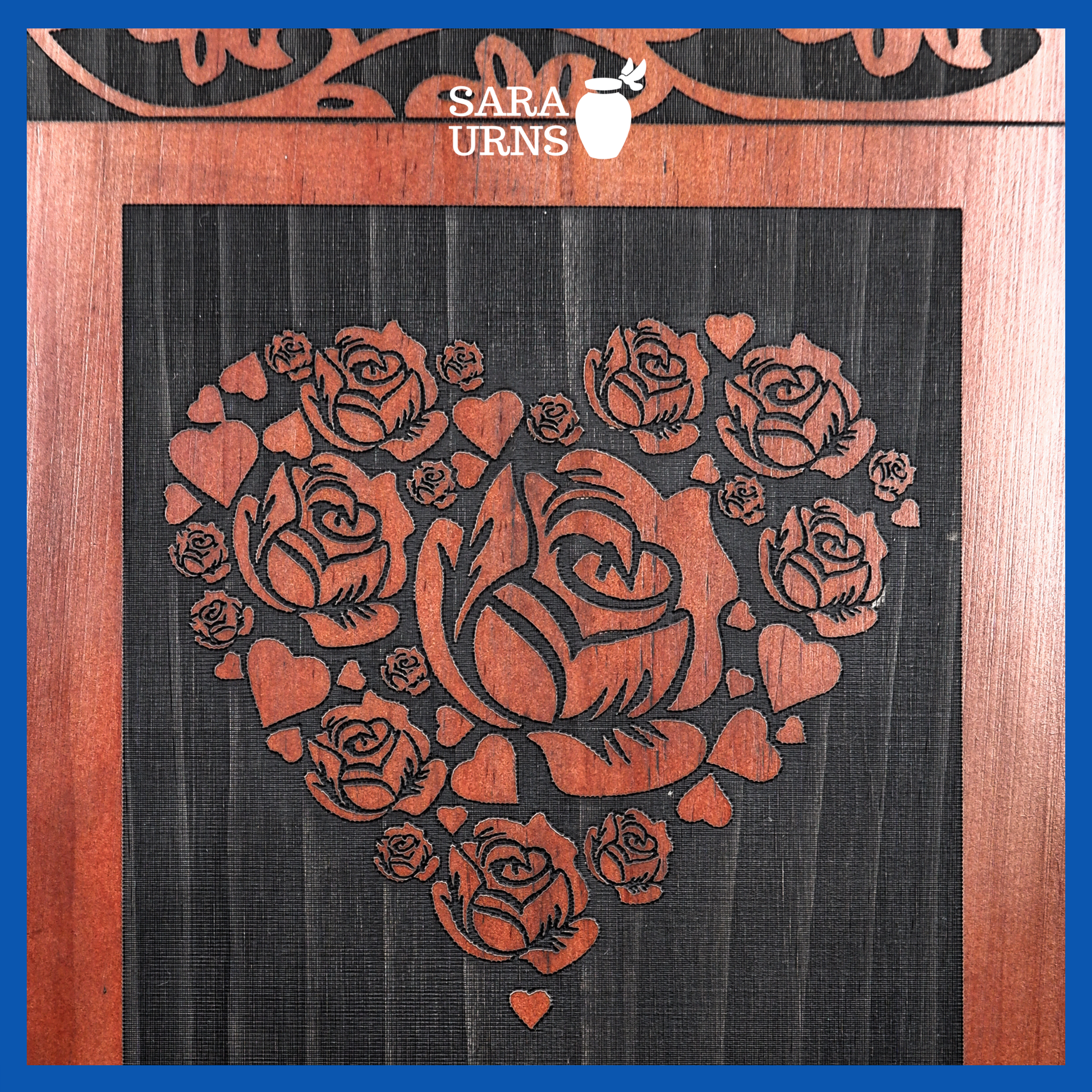 A close-up angle of a terracotta pine wooden urn which highlights its intricate engraving of roses within a heart.