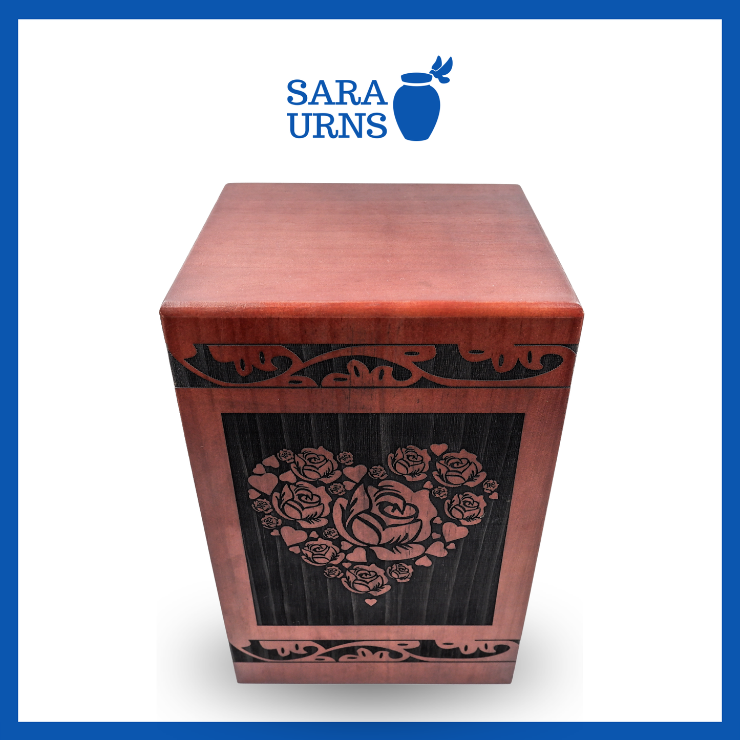A higher angle of a terracotta pine wooden urn with an intricate engraving of roses within a heart over a white background.