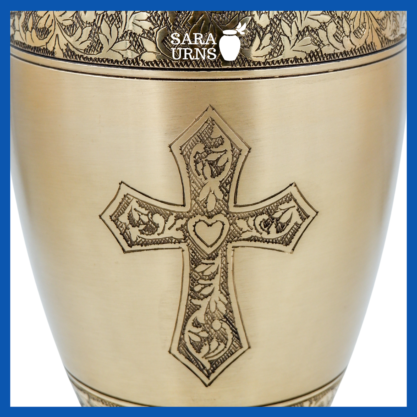 A close-up angle of a gold polished brass metal urn which highlights its hand-etched holy cross.