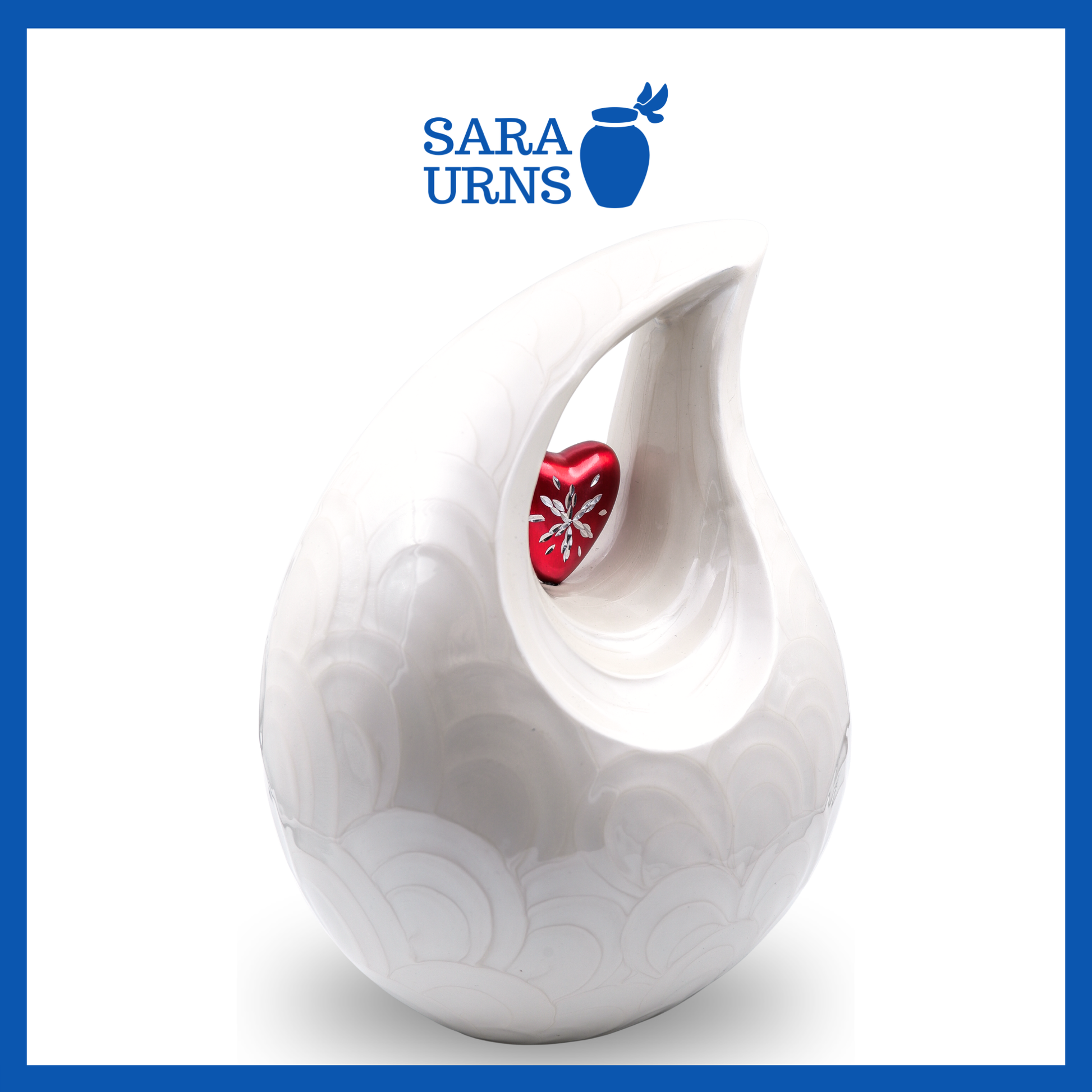 A higher angle of a white polished aluminum metal urn with a droplet shape and heart centerpiece over a white background.