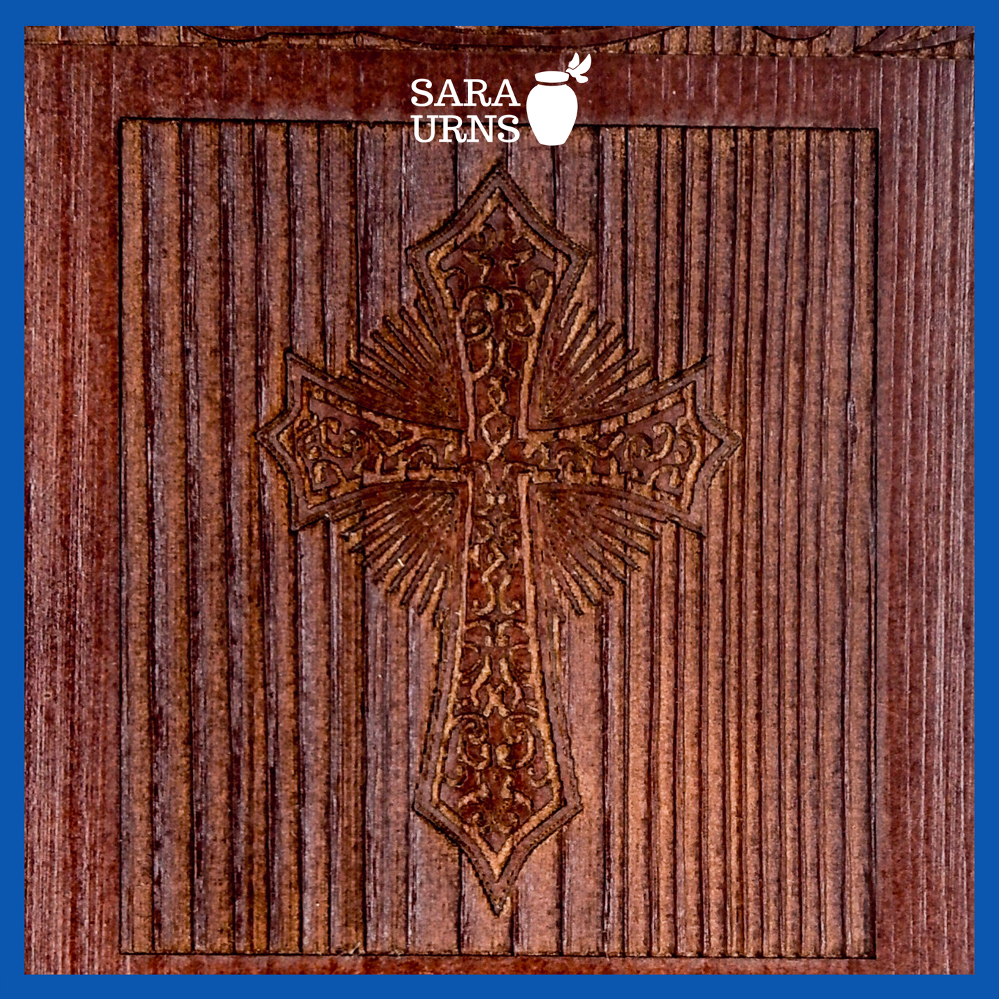A close-up angle of a brown pine wooden keepsake urn with an intricate engraving of the holy cross over a white background.