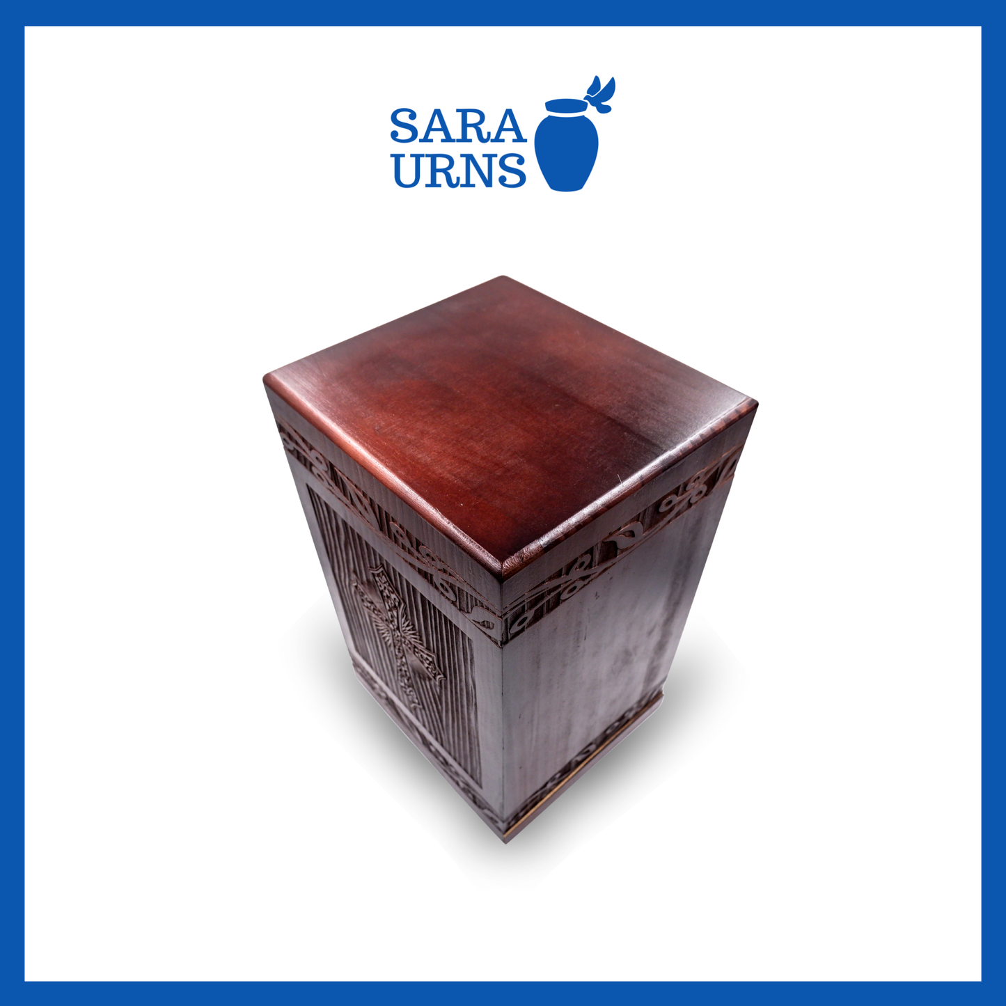 A second, higher angle of a brown pine wooden keepsake urn with an intricate engraving of the holy cross over a white background.