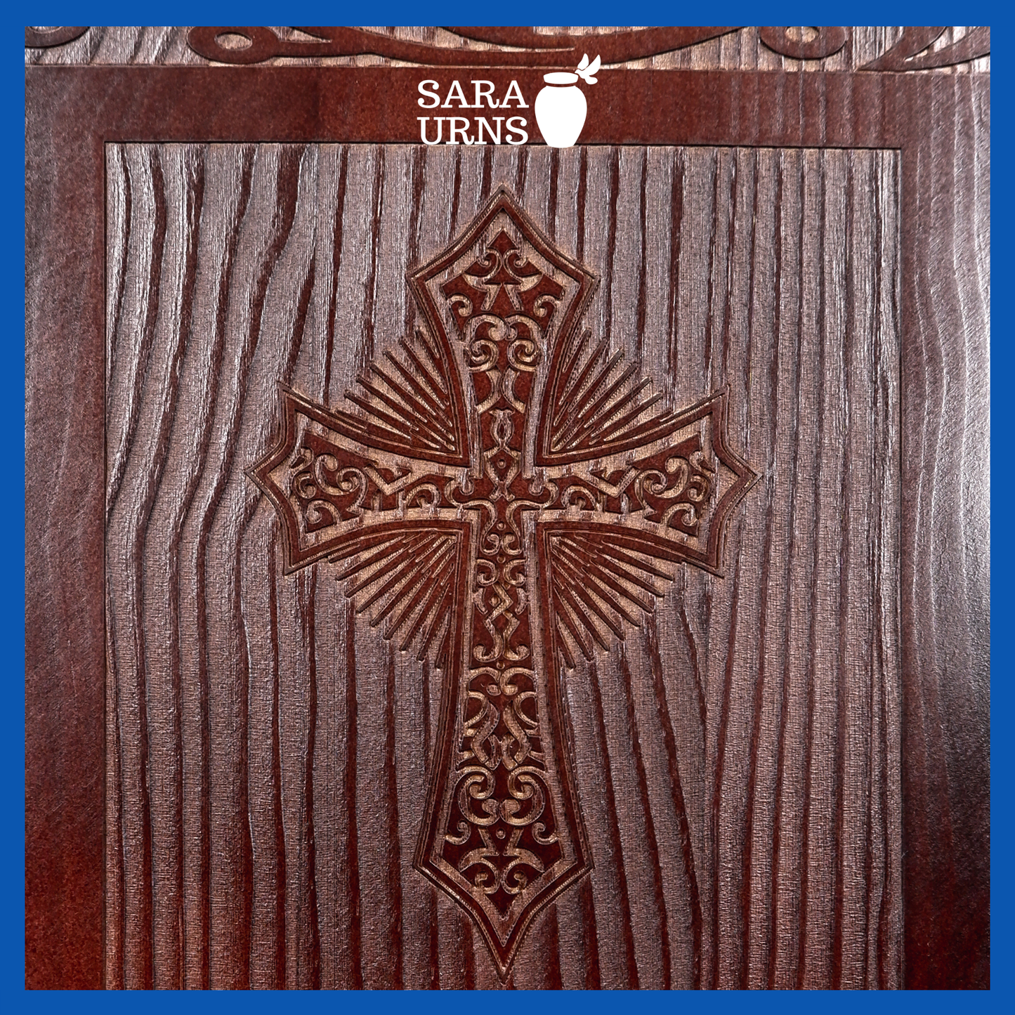 A close-up angle of a brown pine wooden urn with an intricate engraving of the holy cross over a white background.