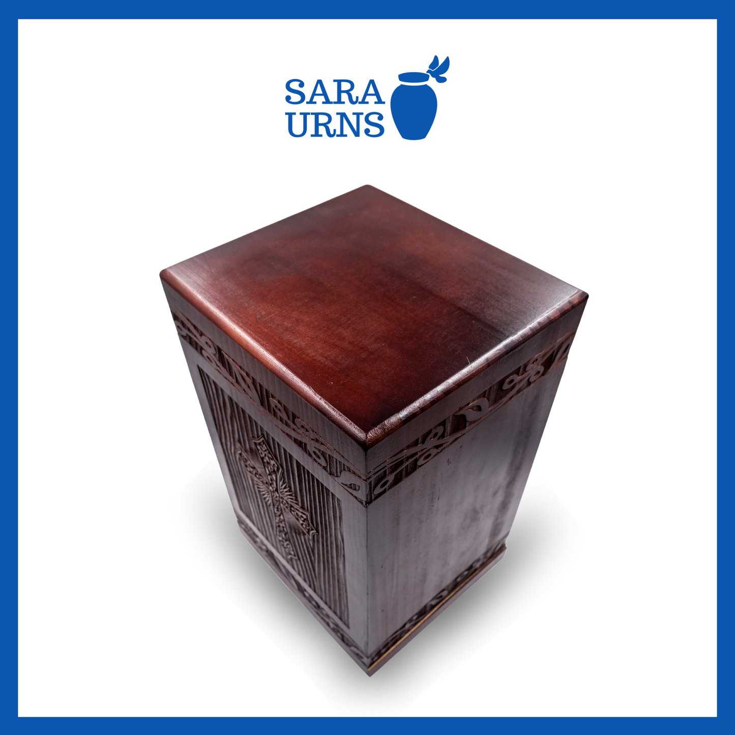 A second, higher angle of a brown pine wooden urn with an intricate engraving of the holy cross over a white background.