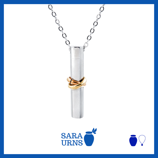 A presentation of an ash necklace with a silver, cylinder-shaped pendant with an infinity wrapped around over a white background.