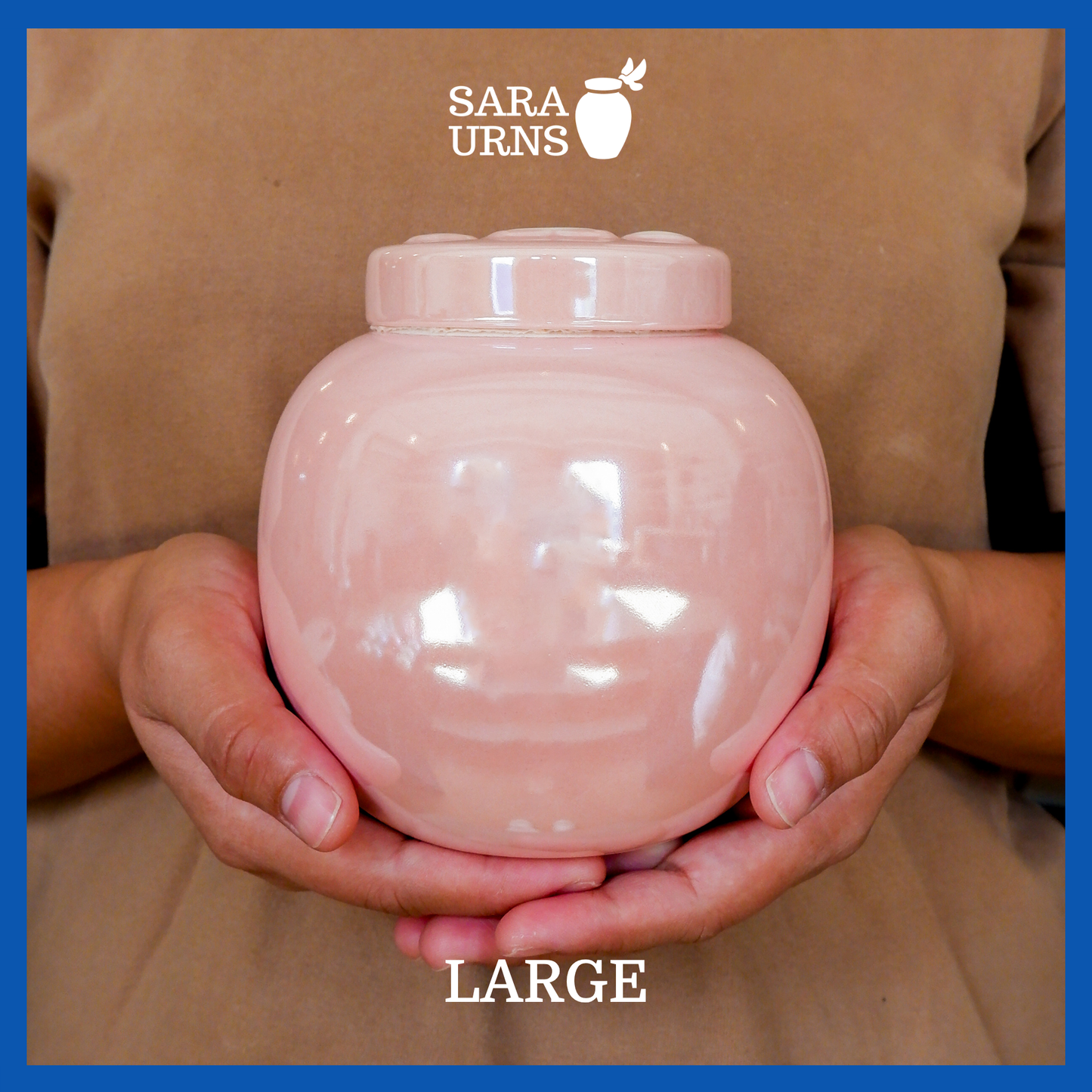 A presentation of a large, pink pearly ceramic pet urn held by an adult woman with two palms.