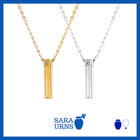 A presentation of a silver pendant with a gold abstract design ash necklace over a white background.