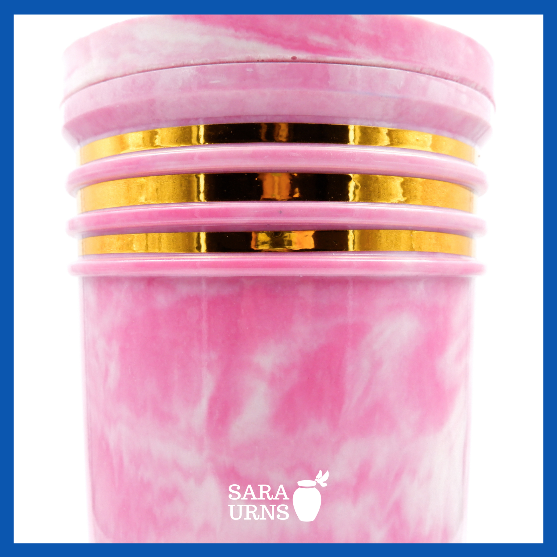 A close-up angle of a pink cultured marble urn which highlights its abstract, liquid marble pattern and gold detail.