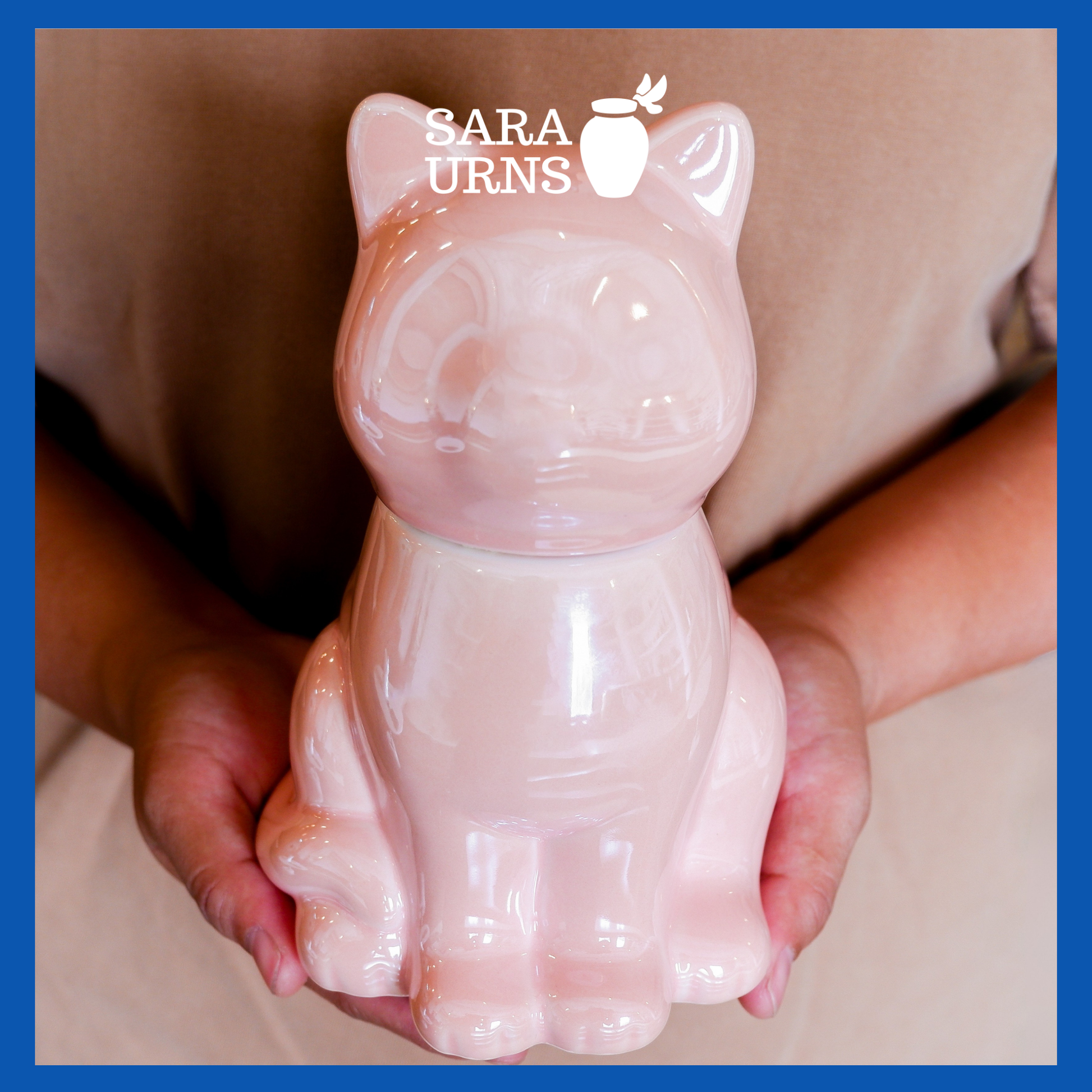 A presentation of a pink ceramic pet urn with a cat-shaped silhouette held by an adult woman with two hands.