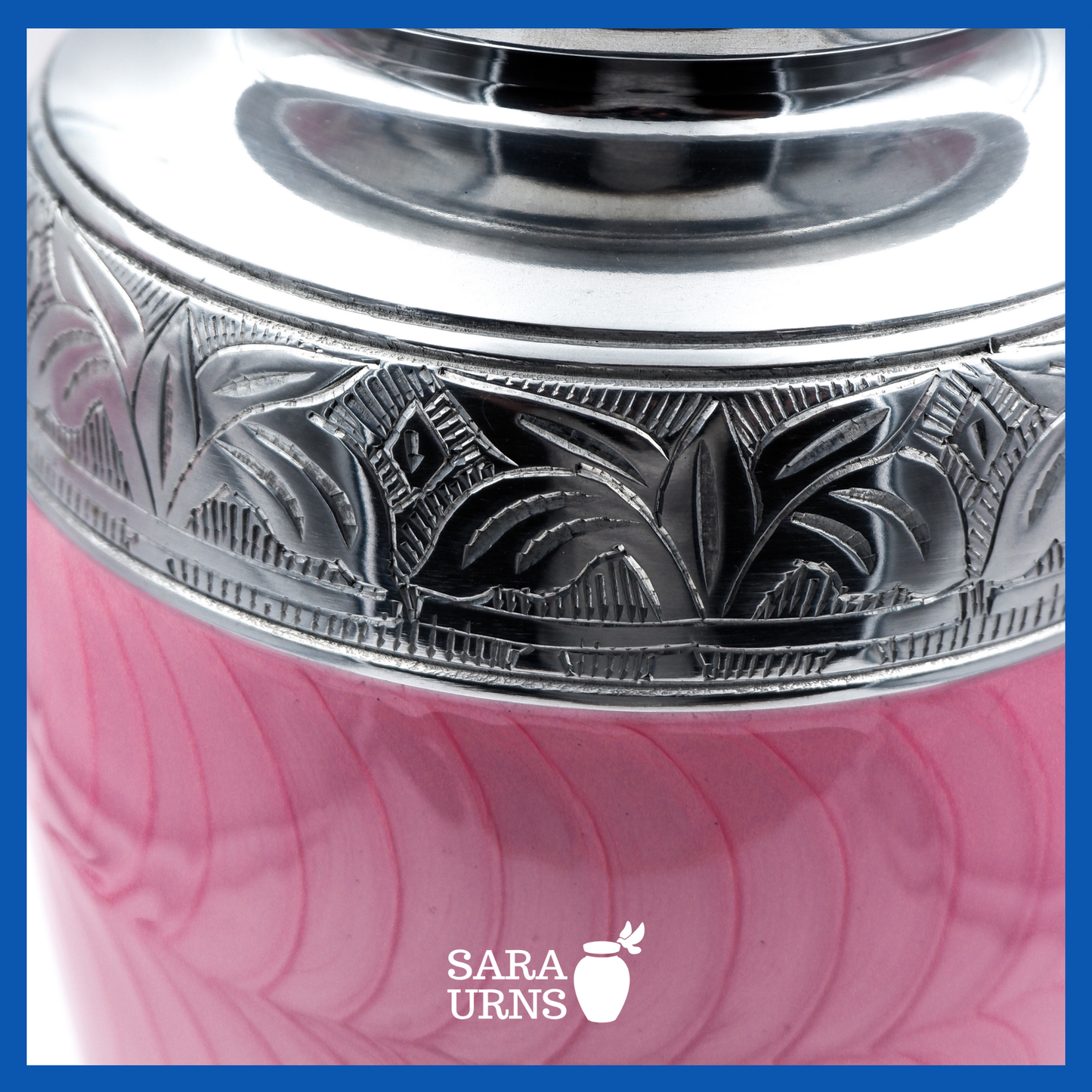 A close-up angle of a pink polished aluminum metal urn with an enamel finish which highlights its silver hand-etched details.