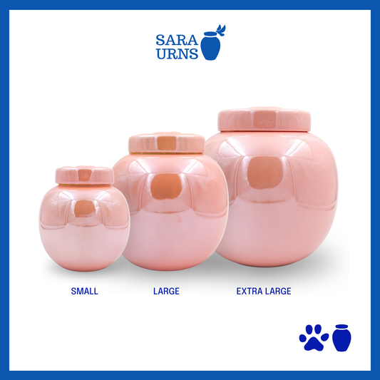 Pink ceramic pet urns with a pearly finish and an embossed paw detail in the lid over a white background.