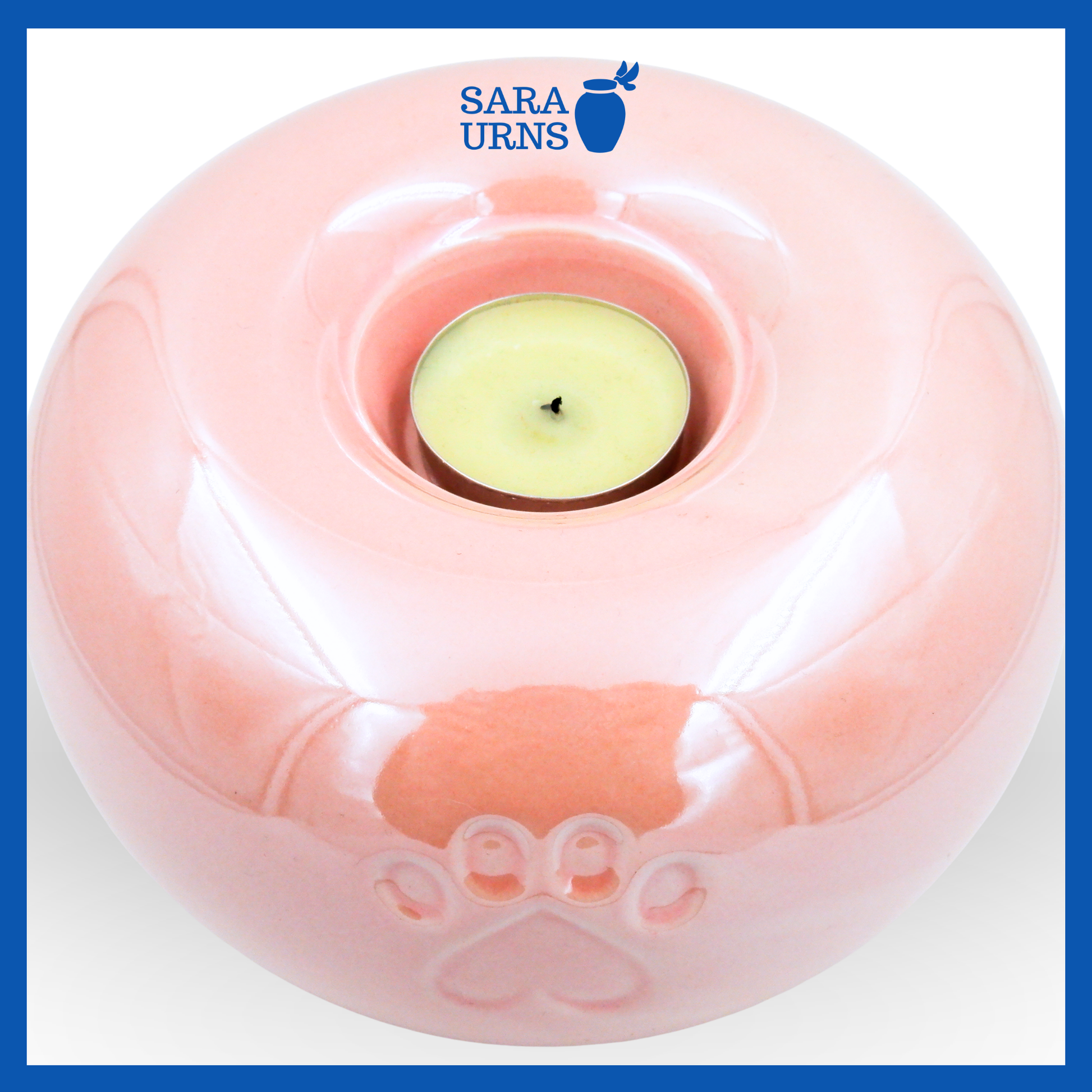 A higher angle of a pink ceramic pet urn with a pearly finish with a candleholder feature.