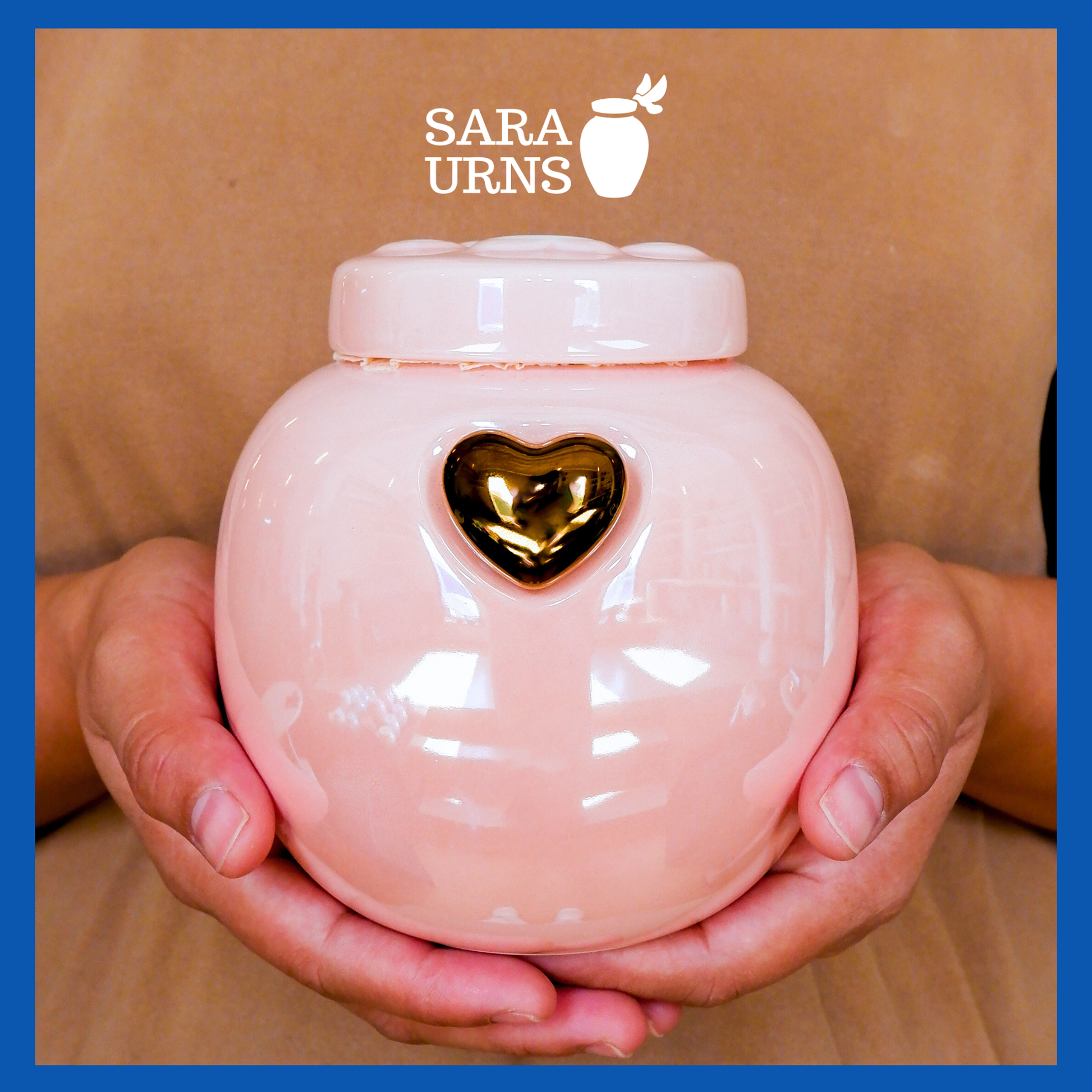 A presentation of a pink ceramic pet urn held by an adult woman with two palms.
