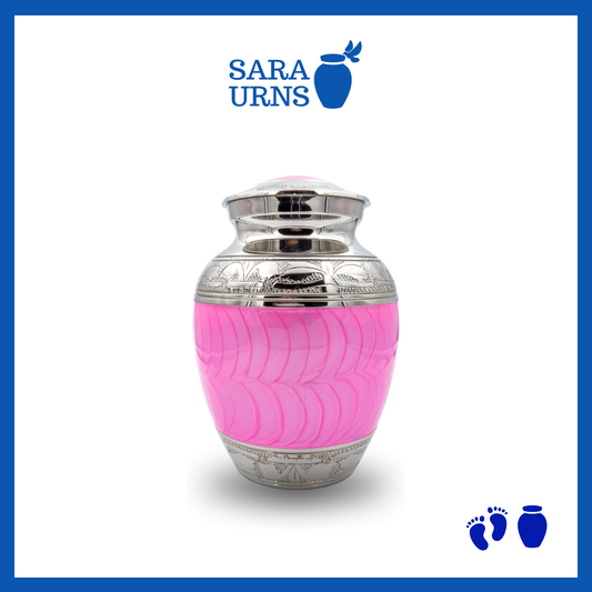 A bright pink polished brass metal baby urn with an enamel finish and hand-etched details over a white background.