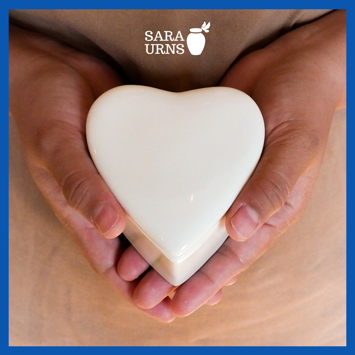 A presentation of a white polished heart-shaped ceramic keepsake urn held by an adult woman with two hands.