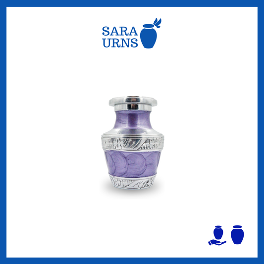 A purple aluminum metal keepsake urn with silver hand-etched designs across the body and lid over a white background.
