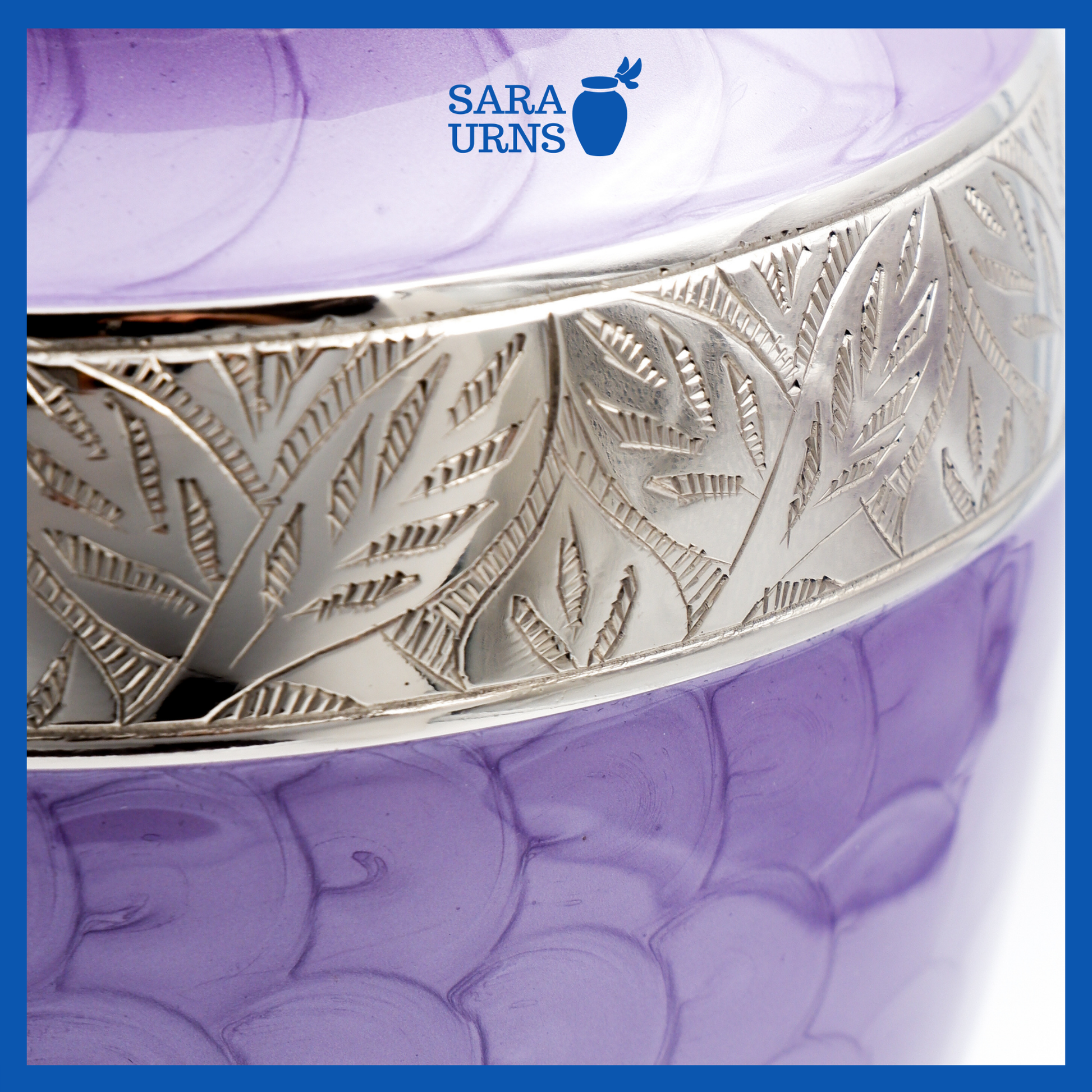 A close-up angle of a purple polished aluminum metal urn with an enamel finish which highlights its silver hand-etched details.