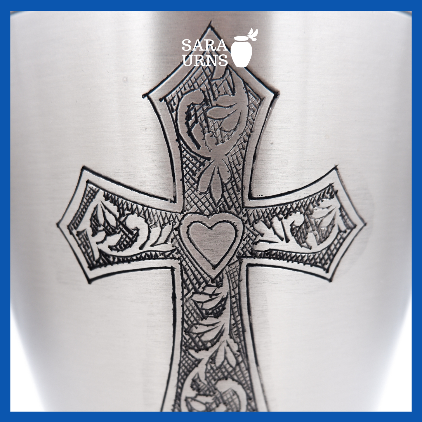 A close-up angle of a silver polished brass metal urn which highlights its hand-etched holy cross.