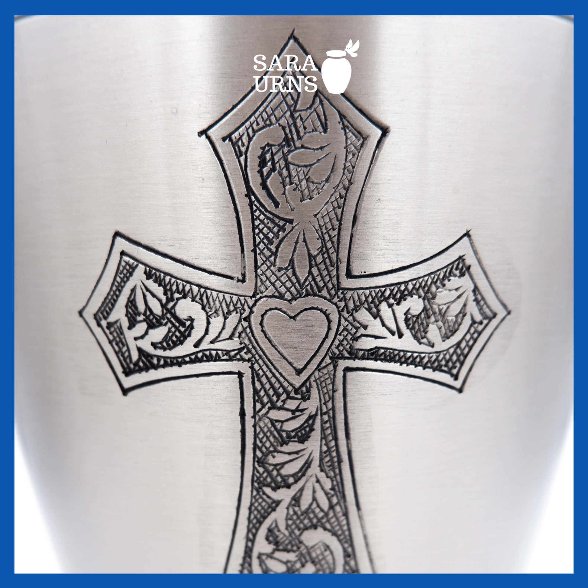 A close-up angle of a silver polished brass metal urn which highlights its hand-etched holy cross.