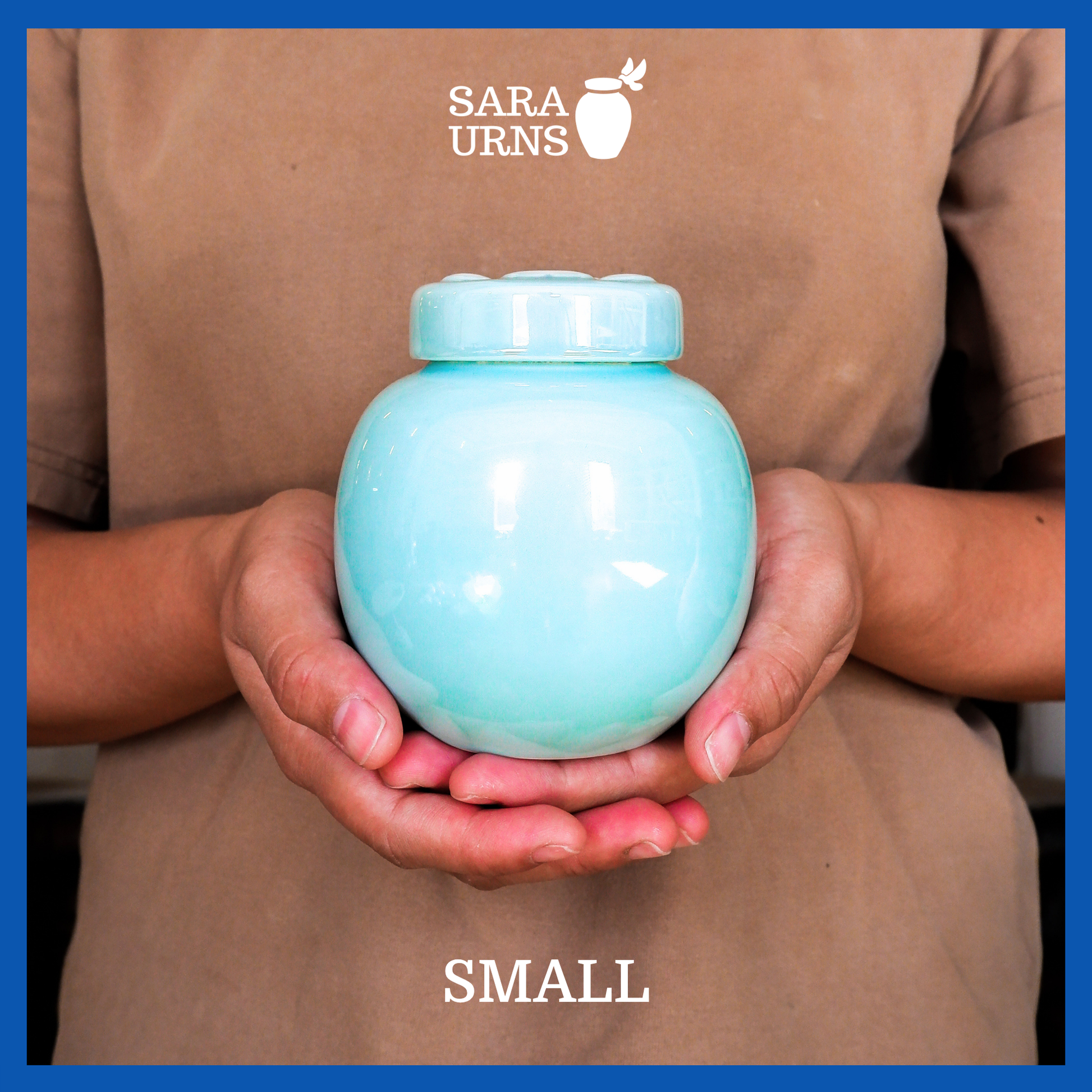 A presentation of a small, blue pearly ceramic pet urn held by an adult woman with two palms.