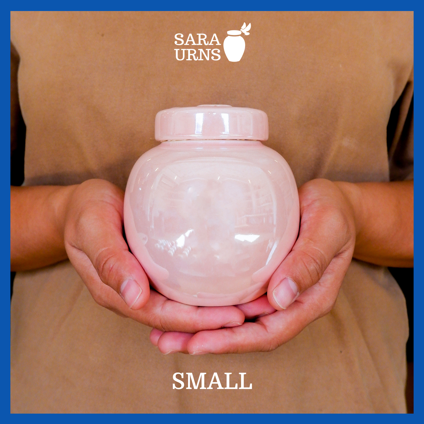 A presentation of a small, pink pearly ceramic pet urn held by an adult woman with two palms.