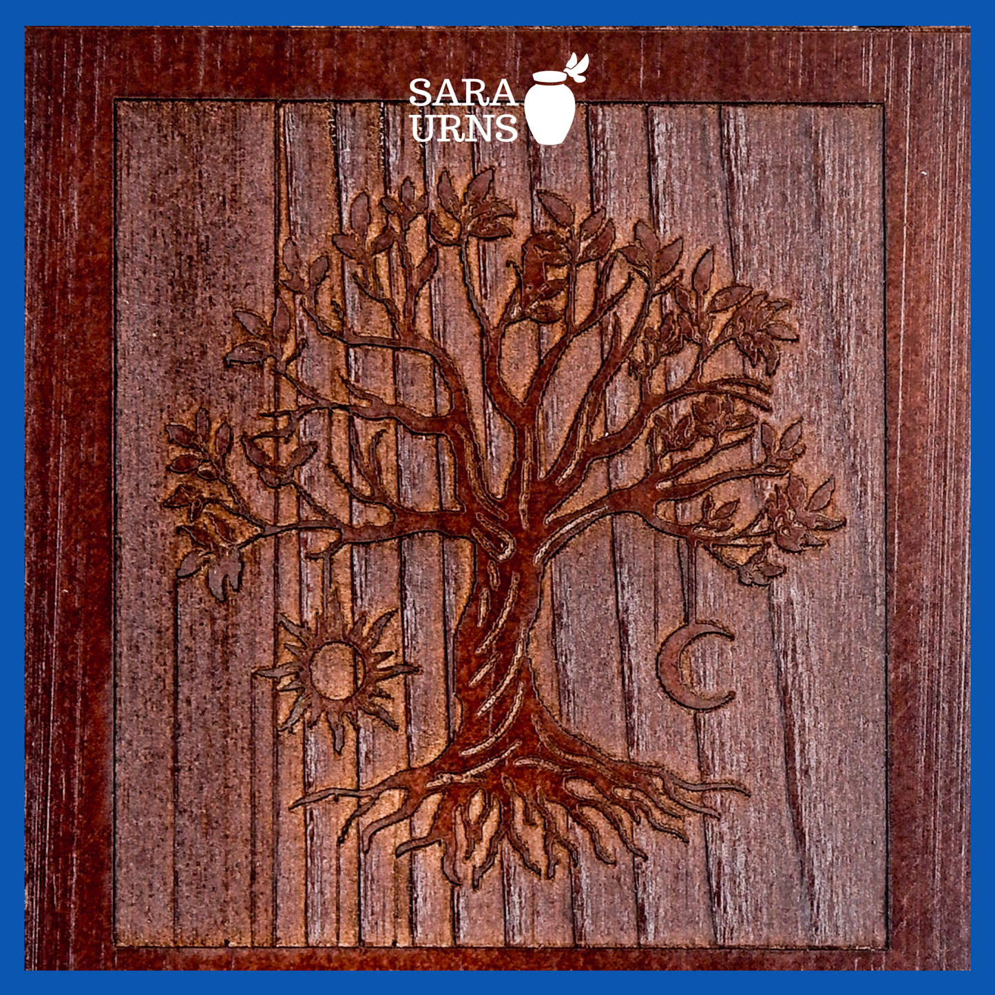 A close-up angle of a brown pine wooden keepsake urn with an intricate engraving of the tree of life over a white background.