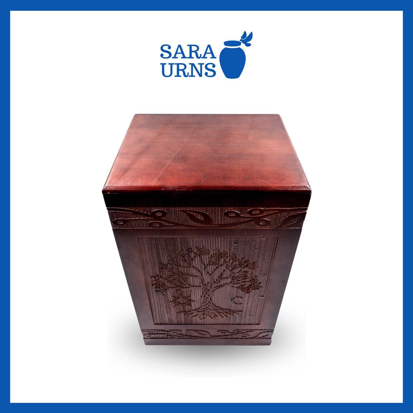A higher angle of a brown pine wooden keepsake urn with an intricate engraving of the tree of life over a white background.