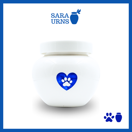 A white polished ceramic pet urn with a blue metallic foiled heart at its center over a white background.