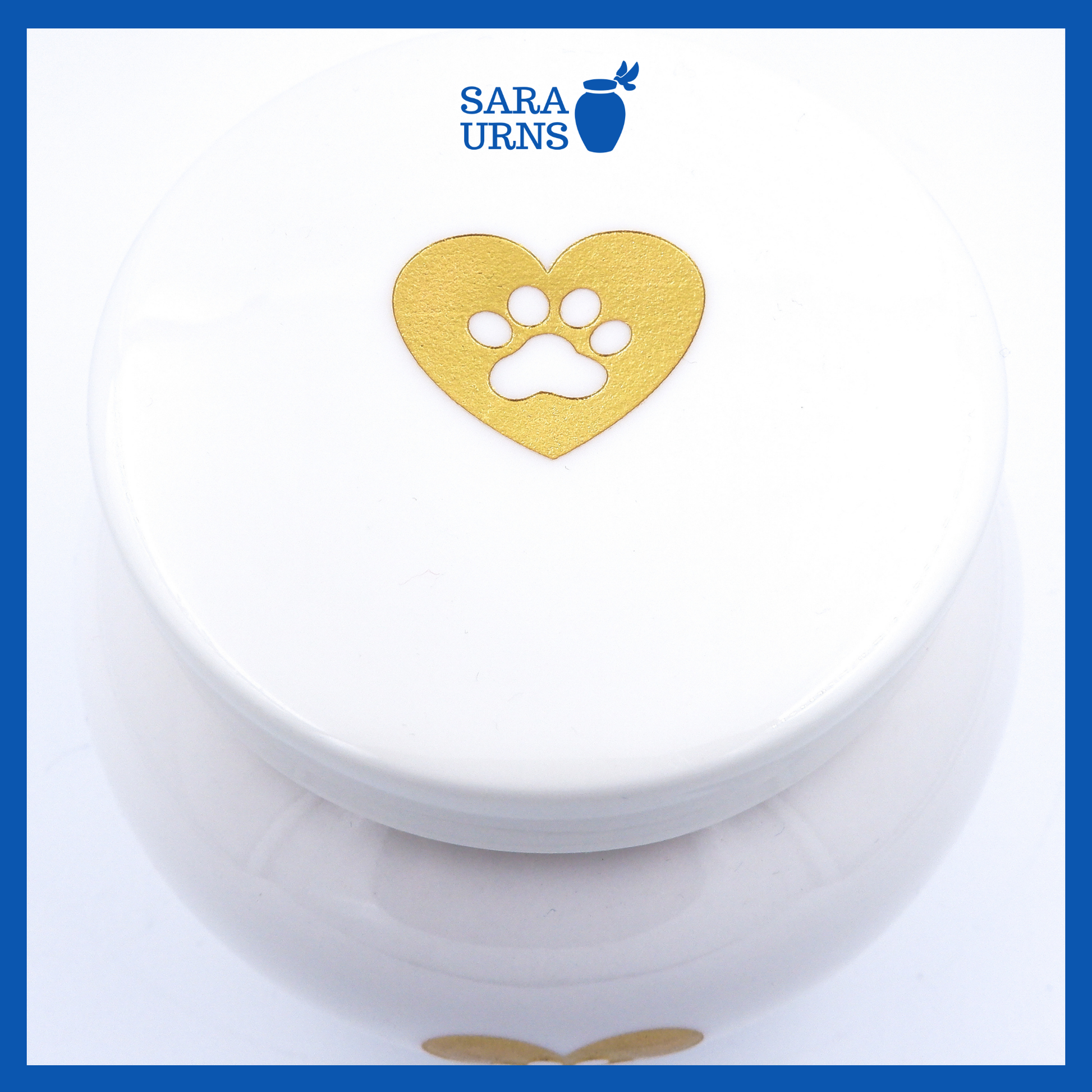 A higher angle of a white polished ceramic pet urn with a gold metallic foiled heart at its center.