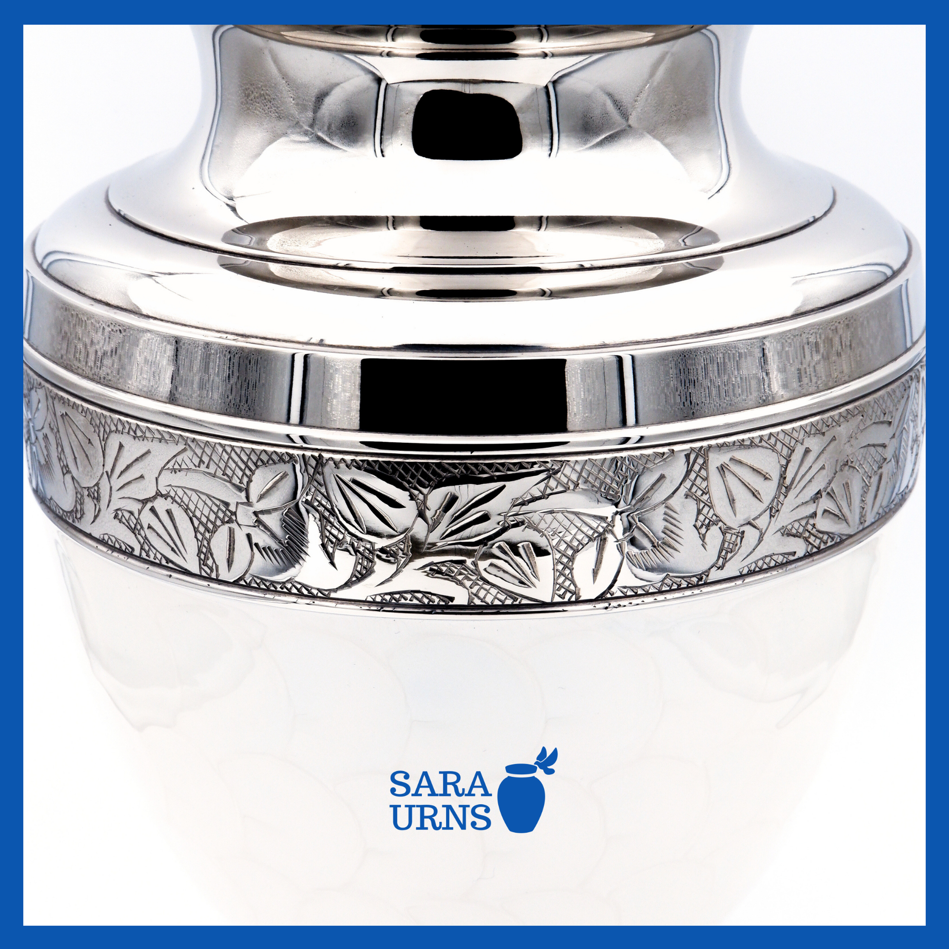 A close-up angle of a white polished brass metal urn which highlights its enamel finish and silver hand-etched details.