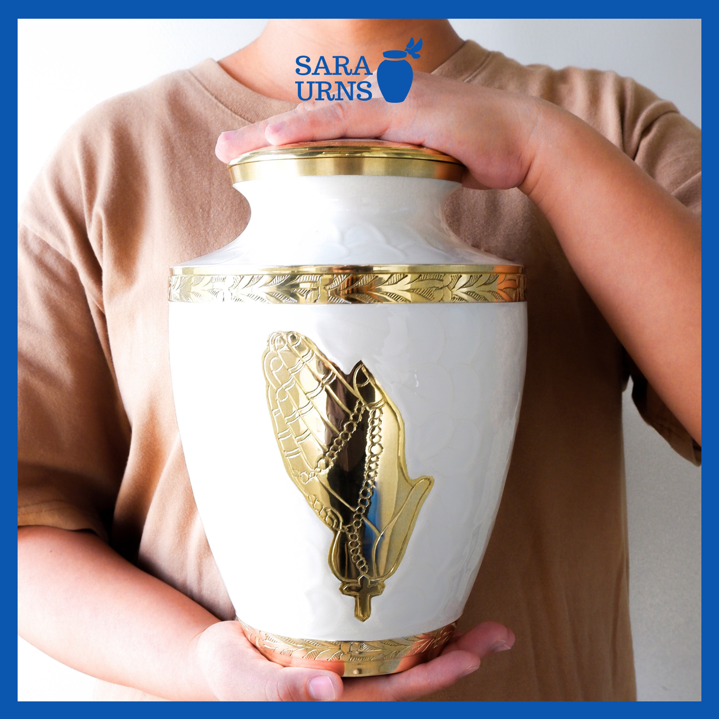 A presentation of a white polished brass metal urn held by an adult woman with two hands.