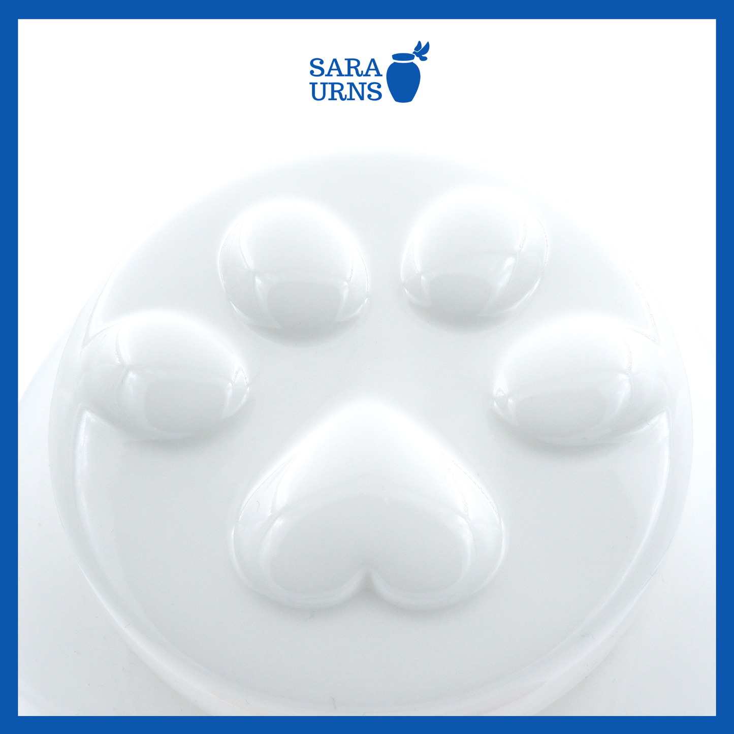 A higher angle of a white ceramic pet urn with an embossed paw detail in the lid over a white background.