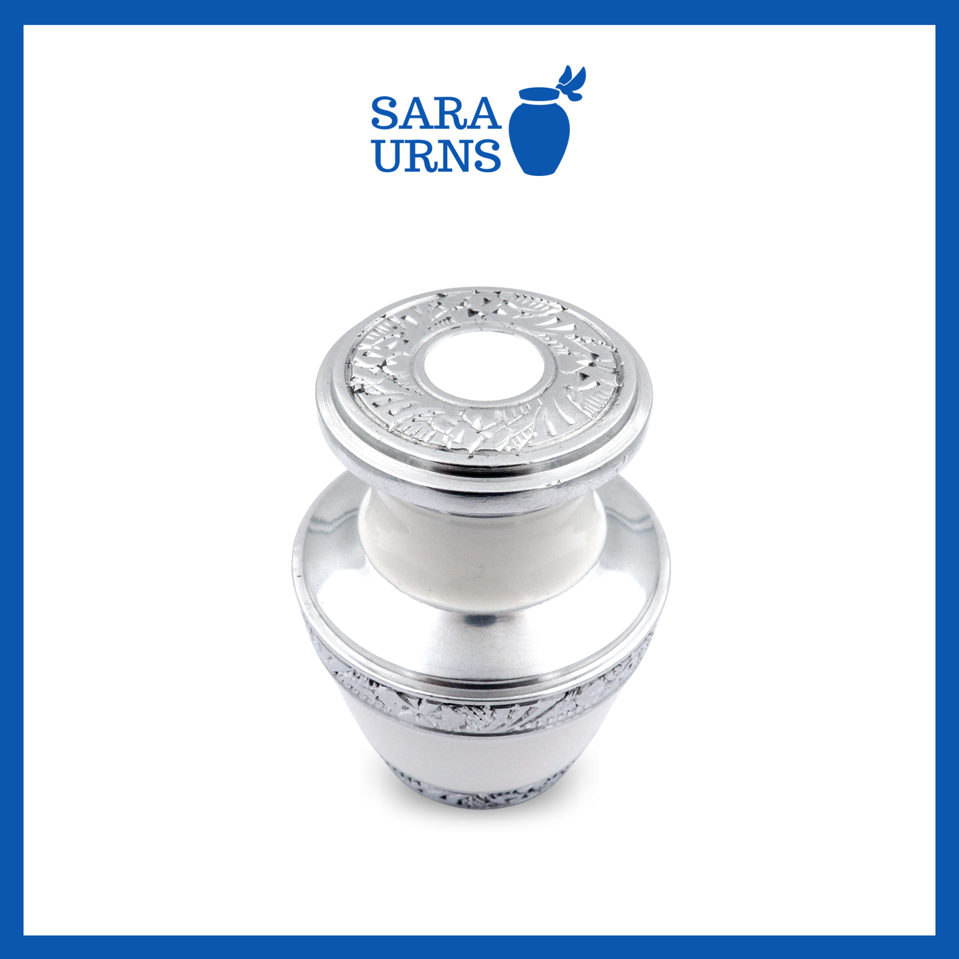 A higher angle of a white aluminum metal keepsake urn with silver hand-etched designs across the body and lid over a white background.