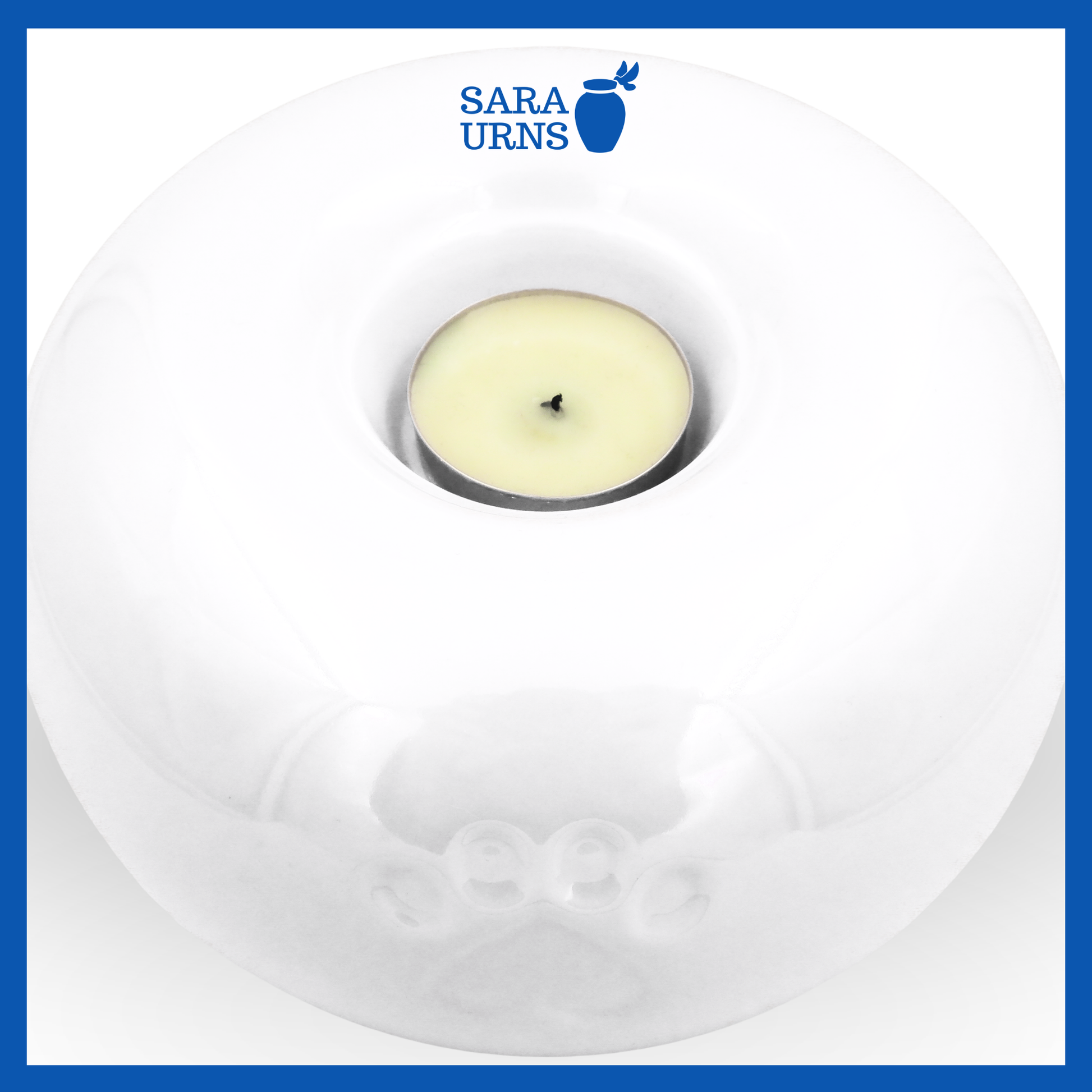 A higher angle of a white ceramic pet urn with a pearly finish with a candleholder feature.